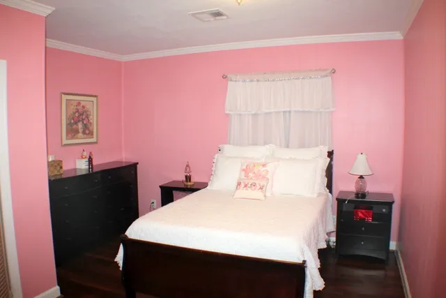 a bedroom with a bed and a desk