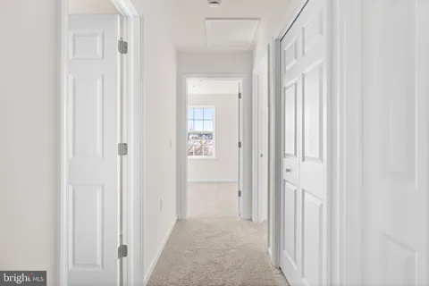 a view of a hallway with a white door