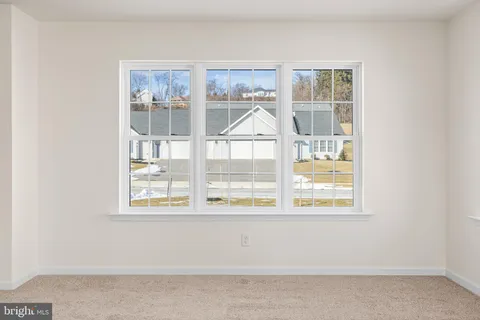 a view of a room that has a window and a kitchen space