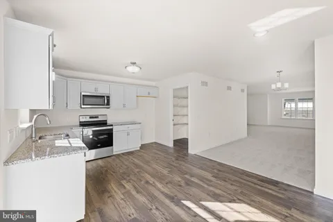 a kitchen with stainless steel appliances a refrigerator and a stove top oven