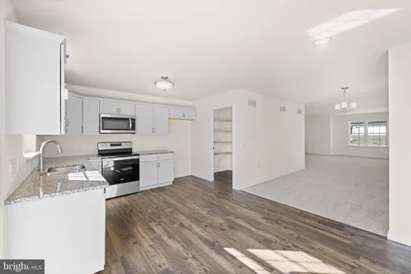 a kitchen with stainless steel appliances a refrigerator and a stove top oven