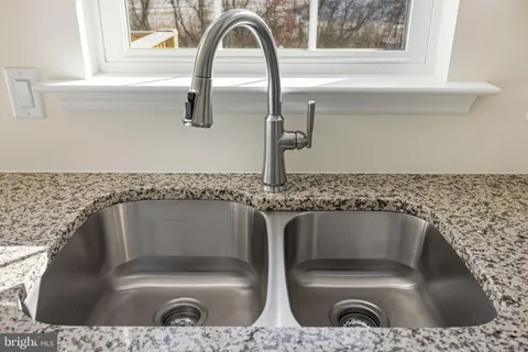 a bathroom with a granite countertop sink