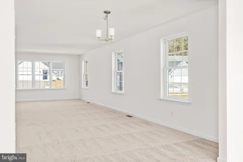 a kitchen with a table chairs stove and cabinets