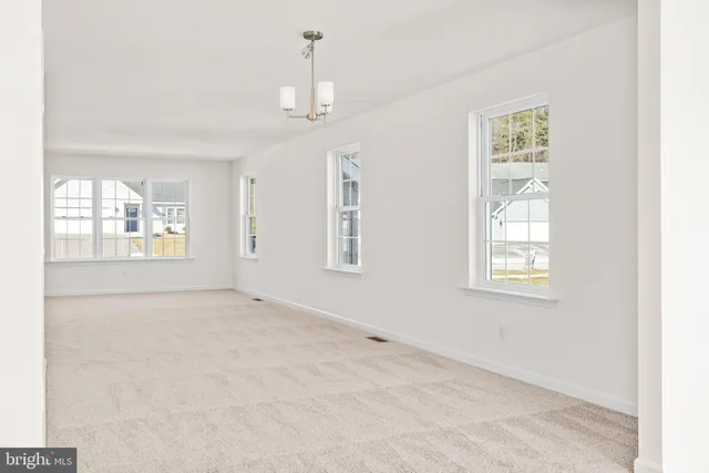 a kitchen with a table chairs stove and cabinets