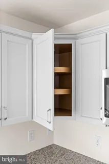 a large kitchen with a large window and white stainless steel appliances