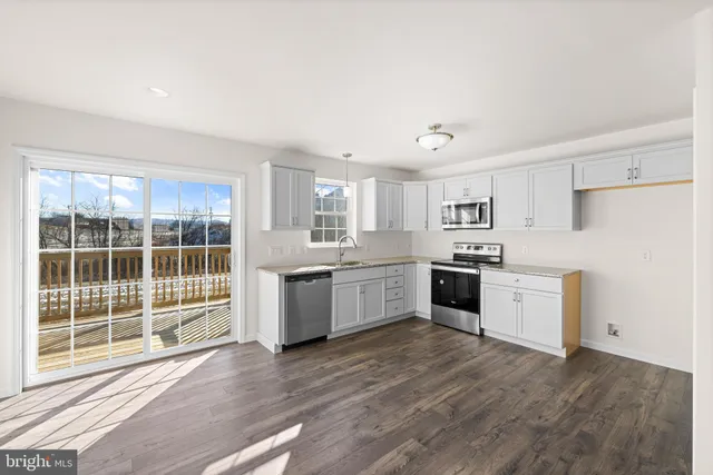 a view of a room that has a window and wooden floor