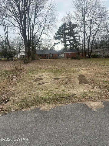 a view of yard covered with snow in front of house