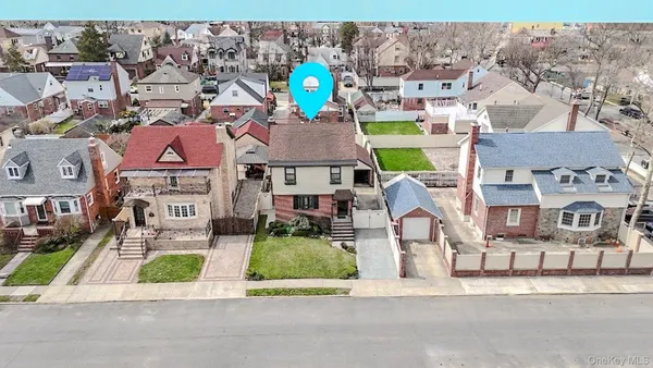 an aerial view of multiple houses with yard