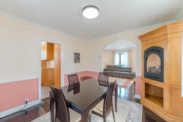 a view of a livingroom with furniture a window and wooden floor