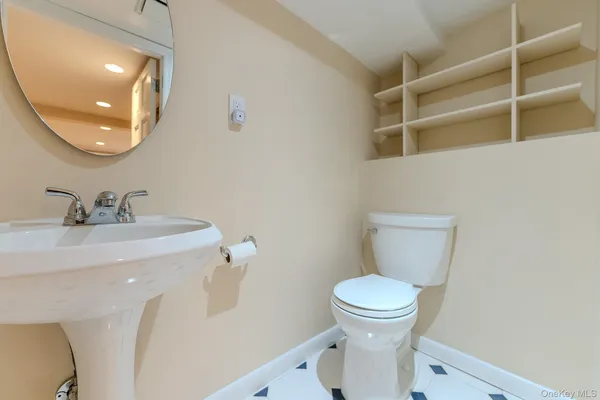 a bathroom with a sink a toilet and a mirror