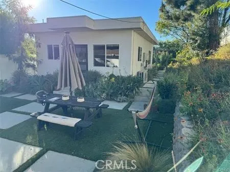a view of a house with a backyard and porch