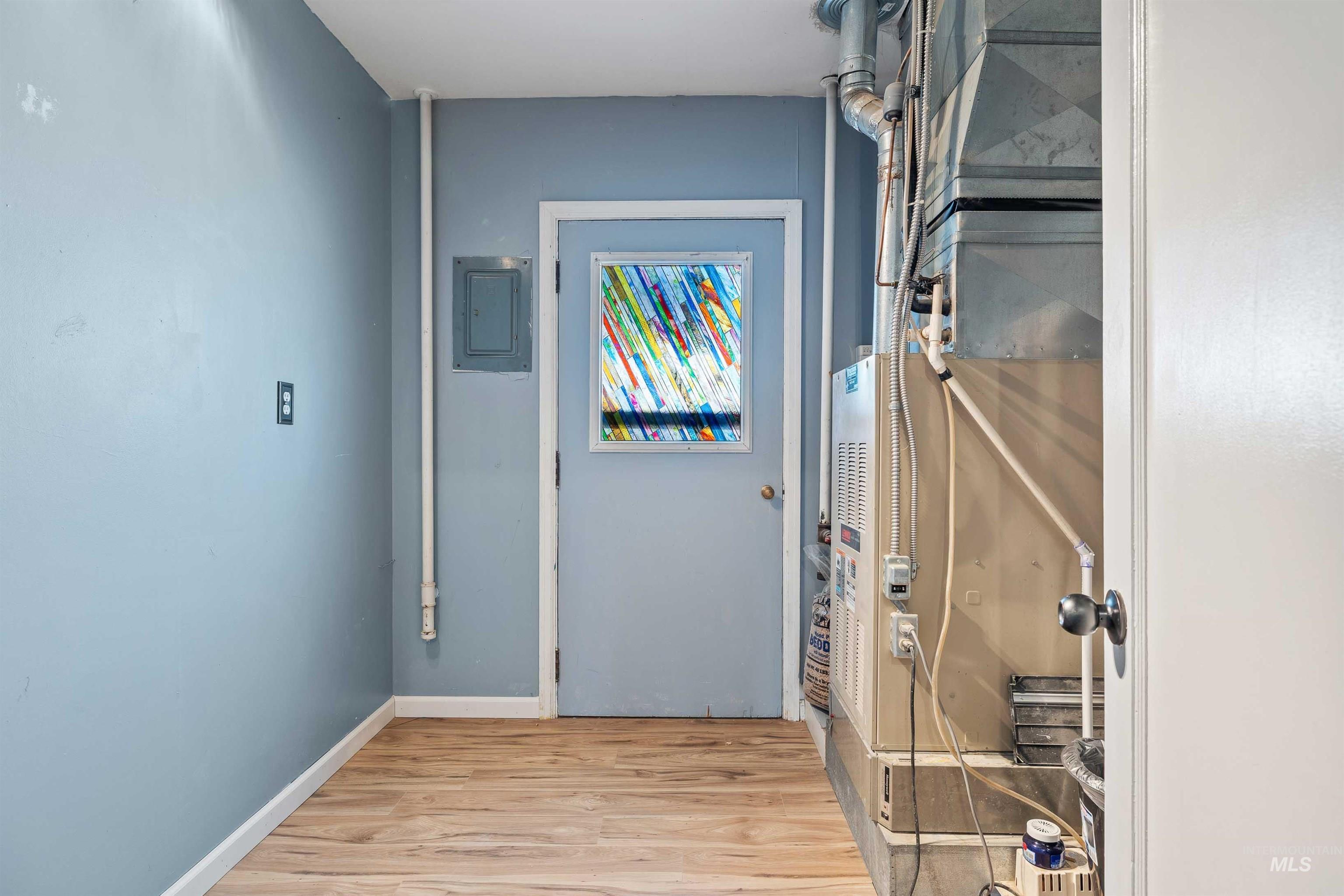817 Union Avenue Filer, ID 83328 - Photo 21 of 37 Hallway with light wood-type flooring, heating unit, and electric panel