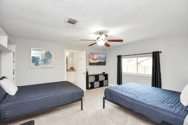 a bedroom with a large bed and a window