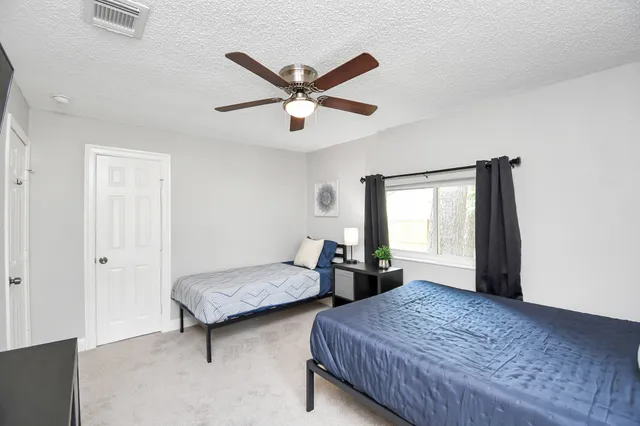 a bedroom with two beds and a window