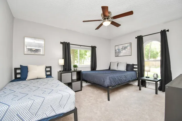 a bedroom with a bed a window and a couch