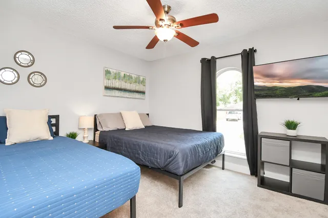 a bedroom with two beds and a window