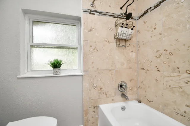 a bathroom with a bathtub and shower