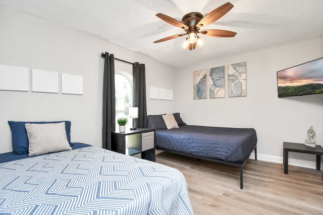 a bedroom with a bed and a chandelier