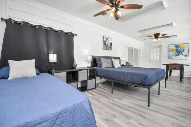 a bedroom with a bed a table and a chandelier