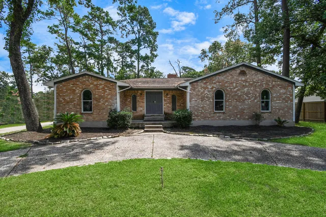 a front view of house with yard and trees