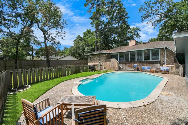 a view of a house with swimming pool and porch