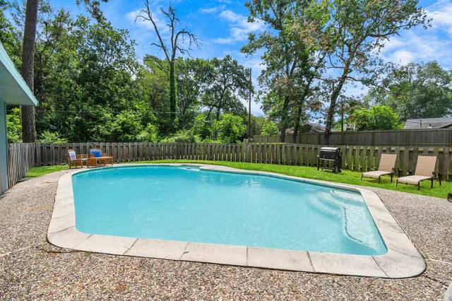 a view of a backyard with swimming pool