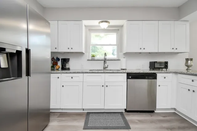 a kitchen with cabinets appliances and a window