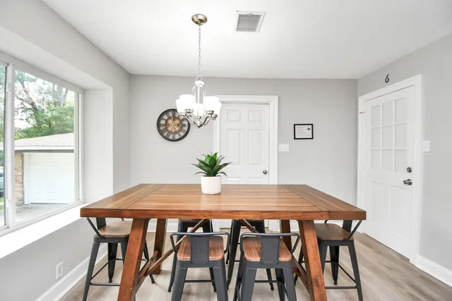 a view of a dining room with furniture window and wooden floor