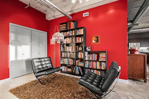 a living room with furniture a rug and a large window