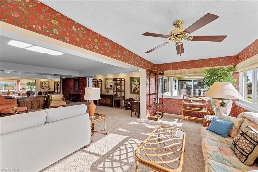 200 Albi Road, Unit 2 Naples, FL 34112 - Photo 12 of 49 a living room with furniture and a large window
