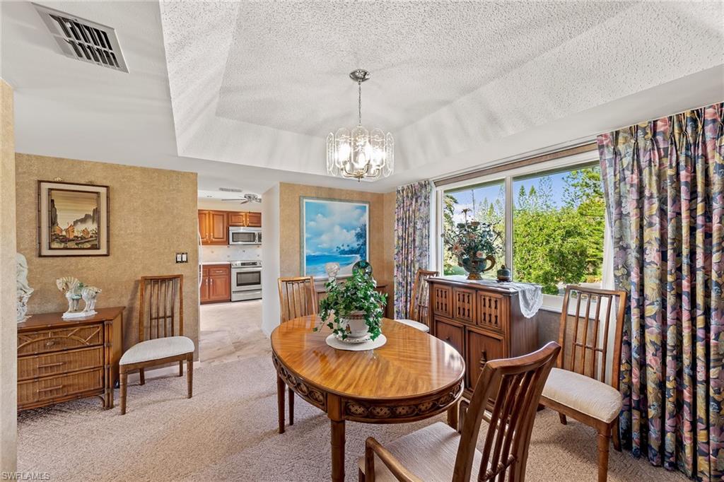200 Albi Road, Unit 2 Naples, FL 34112 - Photo 16 of 49 a view of a dining room with furniture window and outside view