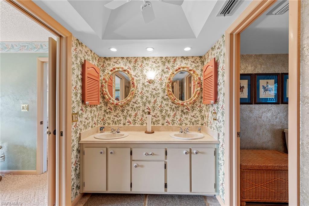 200 Albi Road, Unit 2 Naples, FL 34112 - Photo 25 of 49 a bathroom with a sink and a mirror
