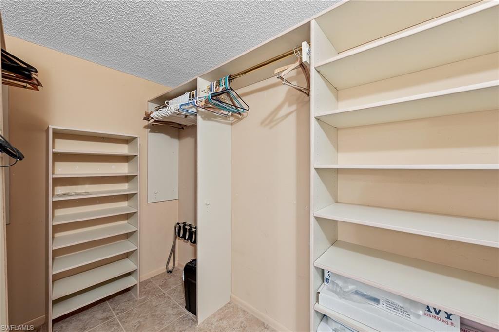 200 Albi Road, Unit 2 Naples, FL 34112 - Photo 27 of 49 a view of walk in closet with empty racks