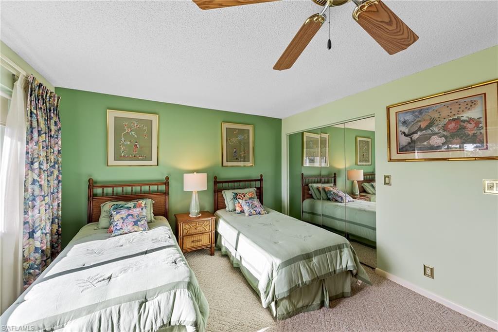 200 Albi Road, Unit 2 Naples, FL 34112 - Photo 29 of 49 a bedroom with double bed and a painting on the wall