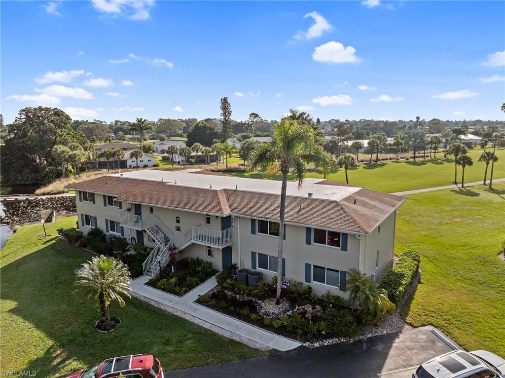 200 Albi Road, Unit 2 Naples, FL 34112 - Photo 4 of 49 a aerial view of a house with a garden and lake view