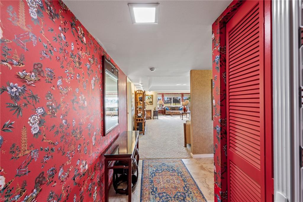 200 Albi Road, Unit 2 Naples, FL 34112 - Photo 7 of 49 a hallway with seating area and hardwood floor