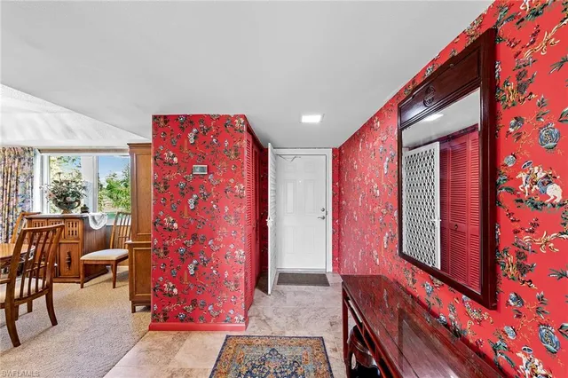 a very nice looking room with a red chair and a large window