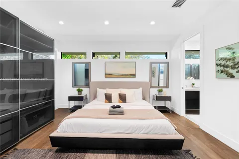 a bedroom with a bed and wooden floor