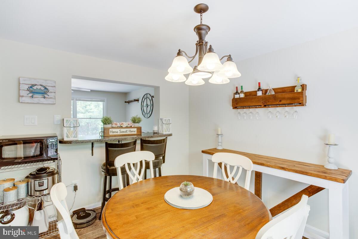 1260 Coster Road Lusby, MD 20657 - Photo 11 of 46 a dining room with furniture and a chandelier