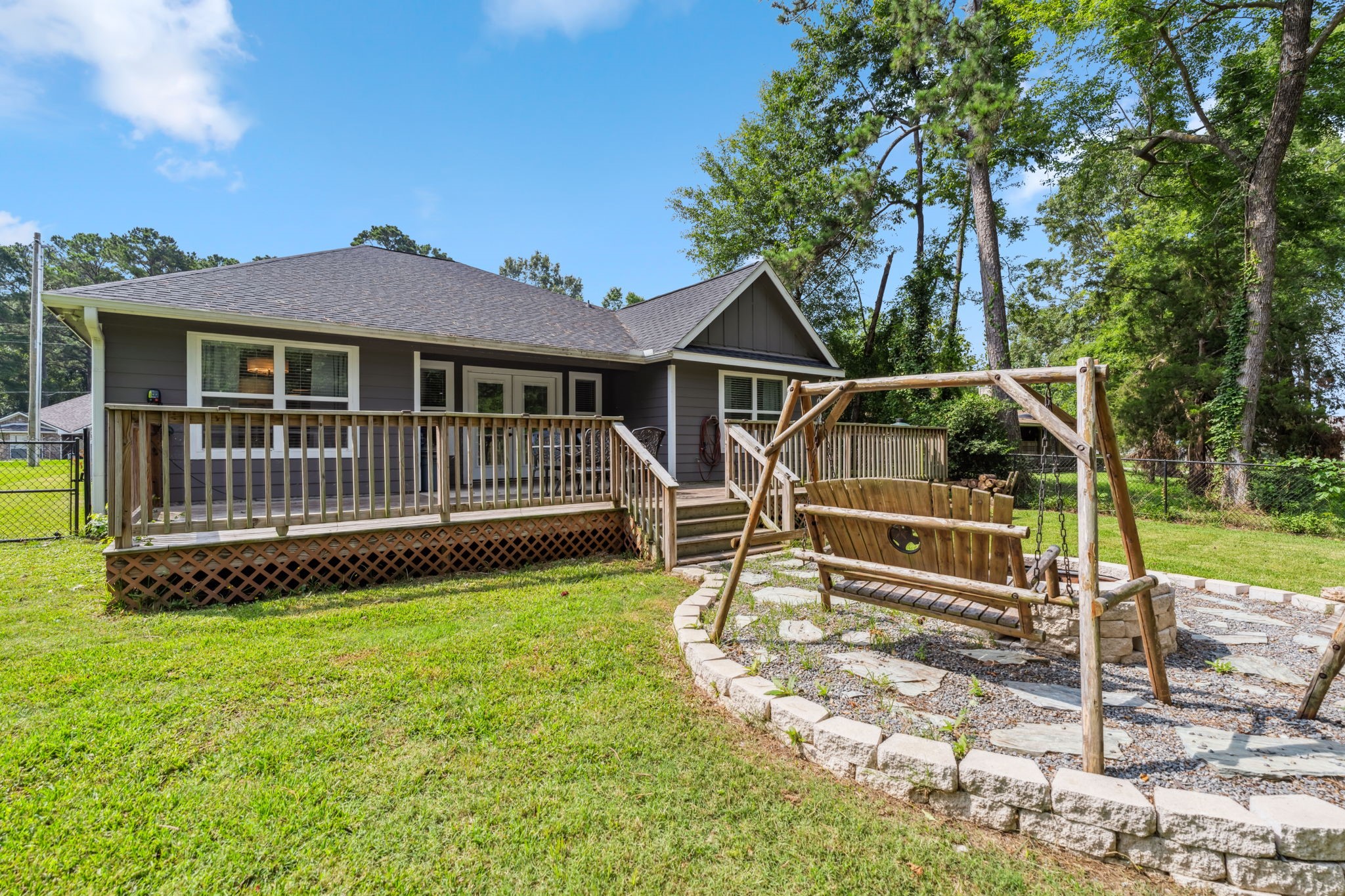 129 Bridgepoint Onalaska, TX 77360 - Photo 26 of 35 a white house with a small yard and large trees