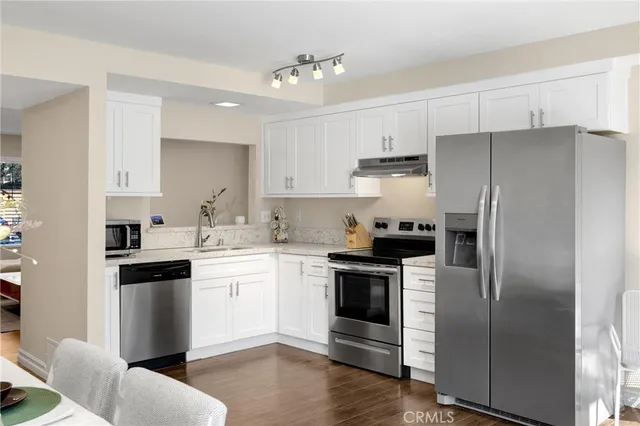 a kitchen with a refrigerator stove and sink