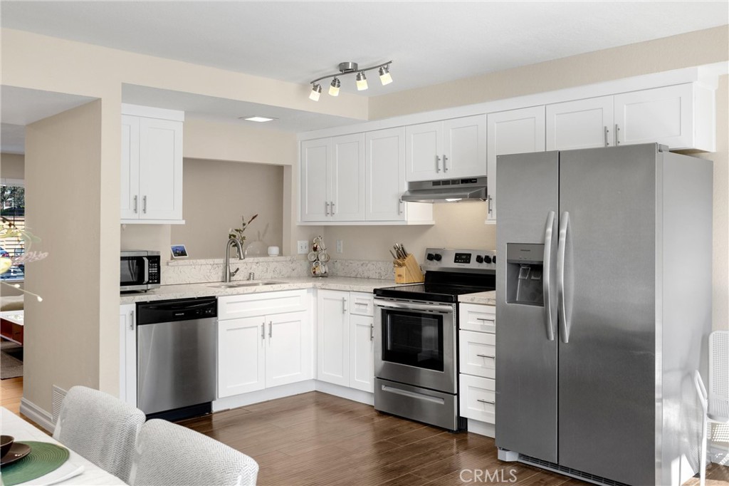 25885 Trabuco Road, Unit 306 Lake Forest, CA 92630 - Photo 12 of 38 a kitchen with a refrigerator stove and sink