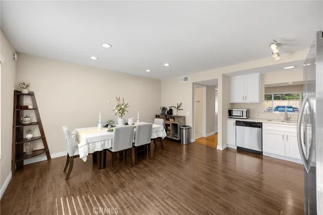 a view of a dining room with furniture and wooden floor