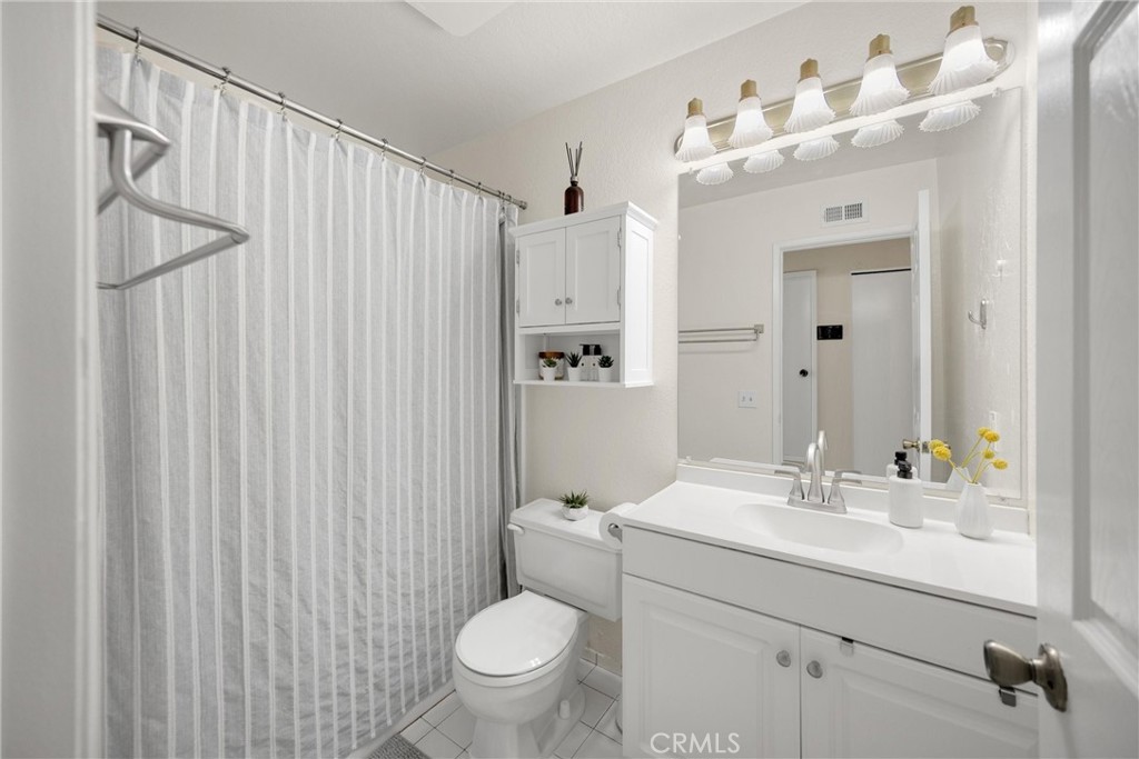 25885 Trabuco Road, Unit 306 Lake Forest, CA 92630 - Photo 19 of 38 a bathroom with a sink a toilet and shower