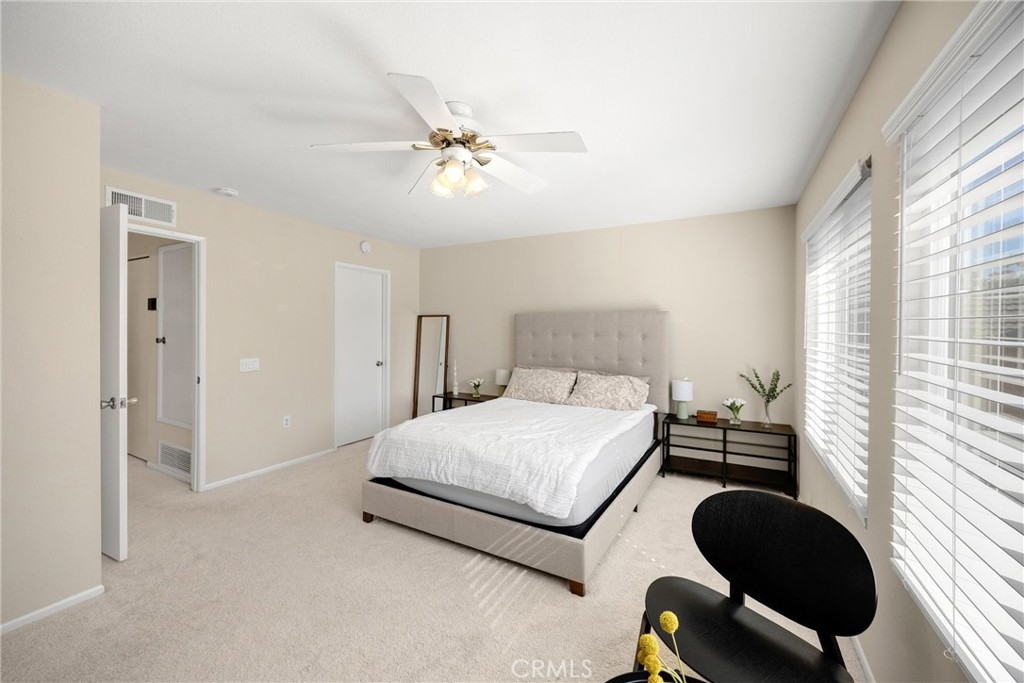 25885 Trabuco Road, Unit 306 Lake Forest, CA 92630 - Photo 21 of 38 a bedroom with a bed and a chandelier