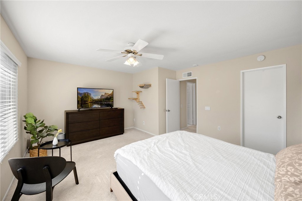 25885 Trabuco Road, Unit 306 Lake Forest, CA 92630 - Photo 22 of 38 a bedroom with a bed and a potted plant