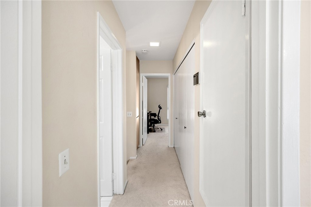 25885 Trabuco Road, Unit 306 Lake Forest, CA 92630 - Photo 23 of 38 a view of a hallway with closet and a bathroom