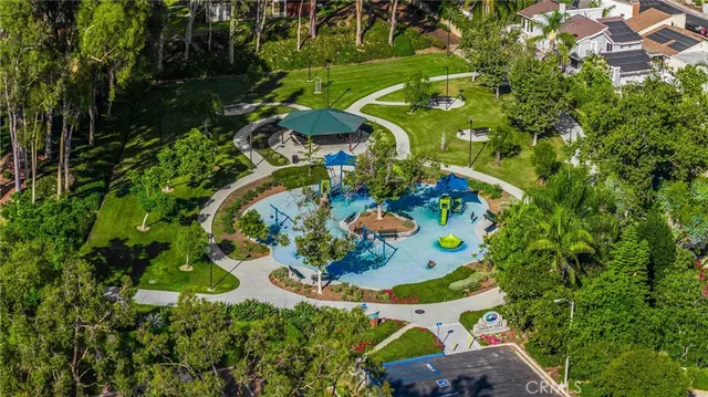 an aerial view of residential house with outdoor space and trees all around