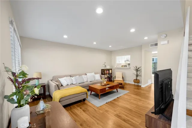 a living room with furniture fireplace and a potted plant