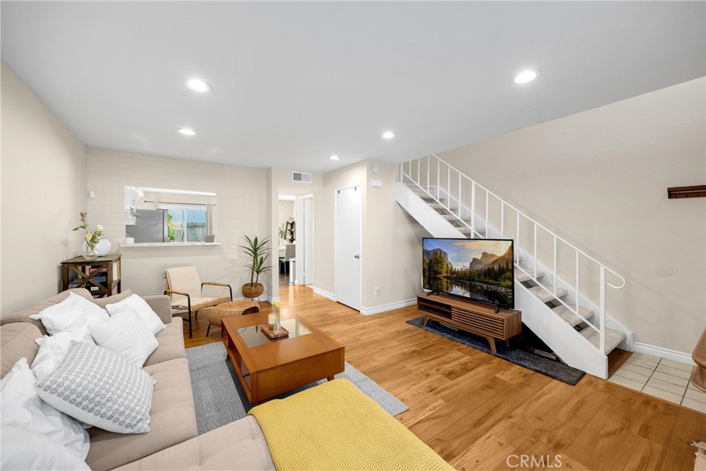 25885 Trabuco Road, Unit 306 Lake Forest, CA 92630 - Photo 5 of 38 a living room with furniture and a flat screen tv